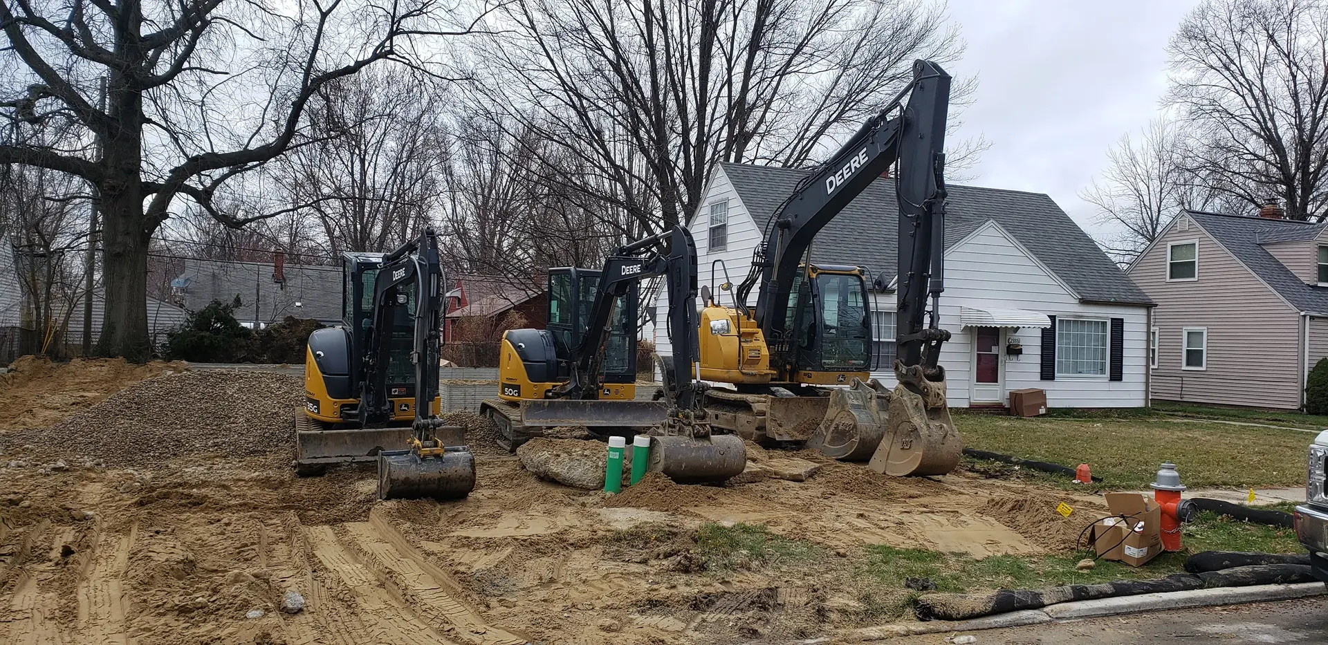 Precision Site Work excavator fleet on a residential dig in Northeast Ohio